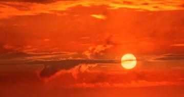 white sun and golden orange sky