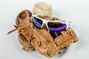 leather baseball glove, sunglasses and ball