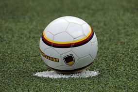 white soccer ball on the soccer field close up