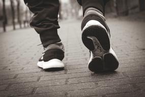 Black and white photo with the black and white running shoes on the legs