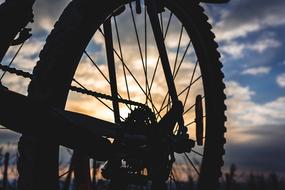 Mountain Bike rear wheel at sunset sky