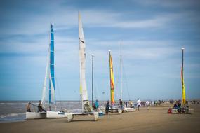 Sailing catamarans on a sandy beach