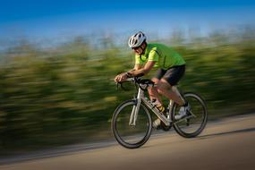 cyclist at speed rides on the road on a blurred background