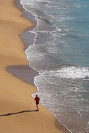 aerial view of the runner on the sandy beach