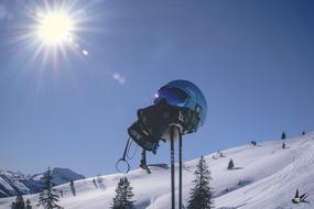 helmet on the ski poles on the ski slope