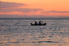 two people canoeing in the ocean