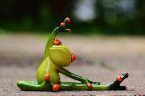 Gymnastics, toy Frog doing exercise on ground