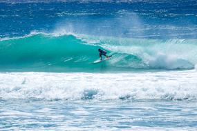 Surfer on turquoise wave, australia, byron bay