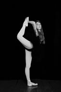 black and white photo of a ballerina with a raised leg