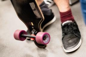 Skateboard at male feet