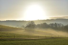 photo of a foggy morning over an agricultural field