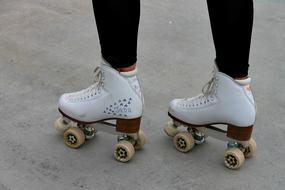 four wheeled retro rollers on the legs of a girl