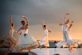 Girls dancing in beautiful white dresses