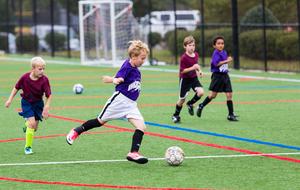 boys team playing football in the stadium