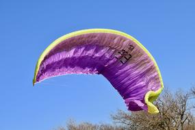 purple and yellow Paragliding Wing at sky