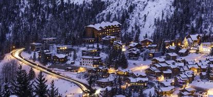 Beautiful Courchevel, with the buildings, with the lights, among the trees, on the snowy mountain, in the winter