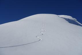 winding ski trace on snowy mountain side