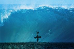 Girl dancing, under the beautiful, turquoise wave