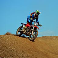 extreme motocross driver in the dust