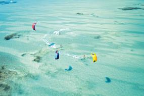 kite surfing on the turquoise sea in Zanzibar