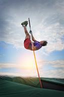 Pole Vaulting man on background with the light