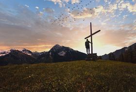 Landscape of the cross on a mountain top at the sunset