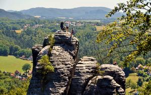 group of people at top of Sandstone rocks at scenic summer landscape, germany, switzerland saxony, rathen