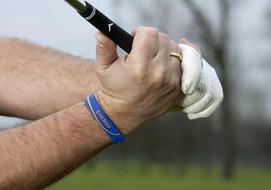 Hands of the golfer equipment on blurred background