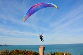 Paragliding over water on a sunny day