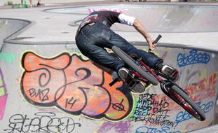 cyclist on the playground with graffiti