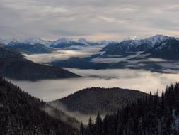 panorama of Olympic Mountains in fog in Washington, USA