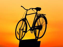 vintage bicycle at sunset sky, installation