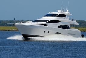 Luxury Yacht Speeding on water at coastline