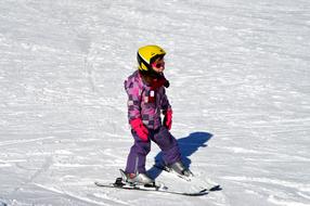 child skiing on a sunny day