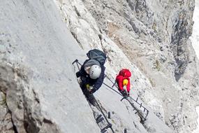 bold climbers on alpine peak