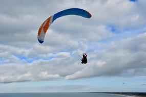 paragliding against a cloudy sky