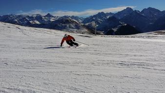 skier on turn at scenic mountains