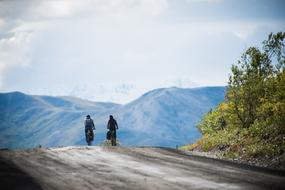 People, biking on the beautiful mountain with colorful trees in Alaska, USA