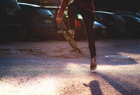 Skateboarder jumping on pavement