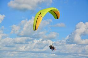 Paraglider at scenic clouds