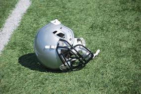 gray football helmet on the field