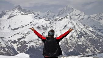 Bac view of a girl in hat, near the beautiful, snowy Zermatt mountain in Switzerland