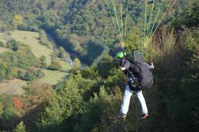 Paragliding landing at forest