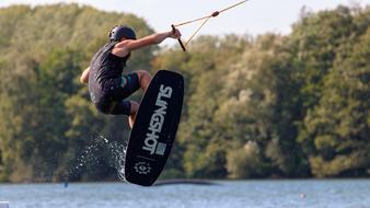 athlete jumps on a wakeboard