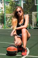 photo of a girl with a basketball on a basketball court