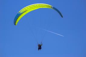 paraglider on the blue sky background