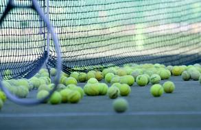 balls and tennis net on the sports field