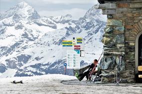 Ski at stone wall in view of mountains