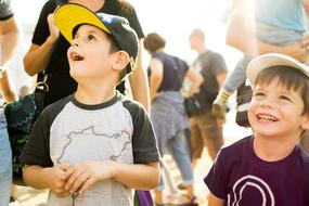 two Child Boys looking Surprised in crowd