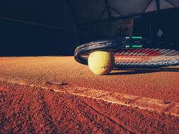 racket and ball on the tennis court